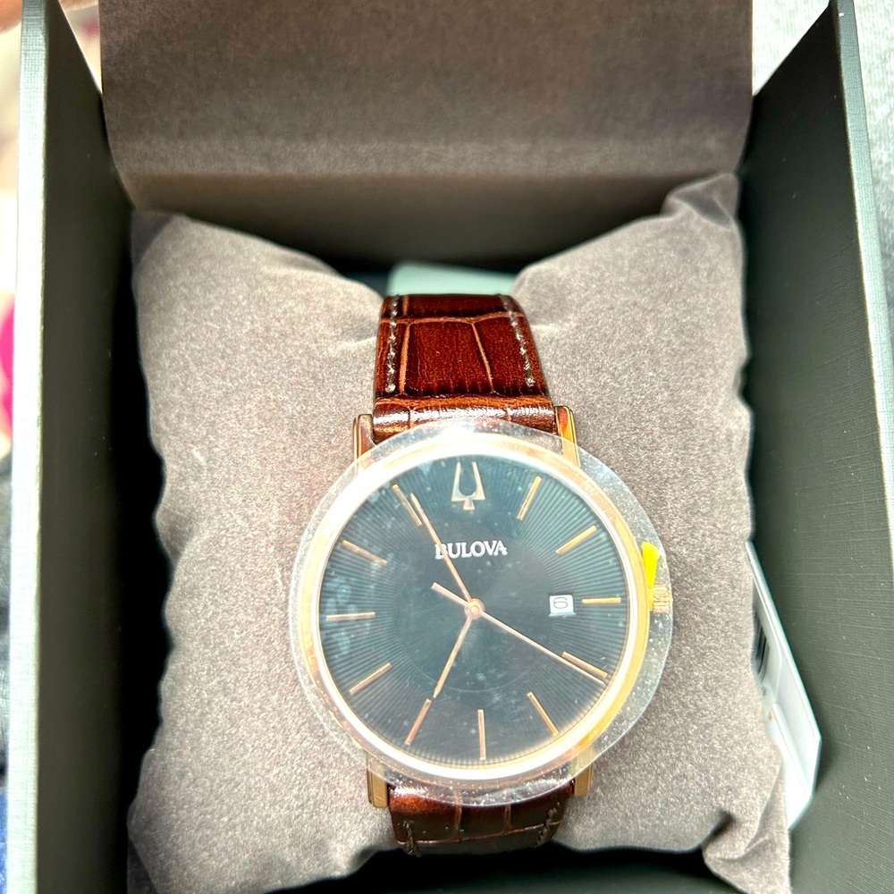 BET. Bulova unisex black face brown band watch